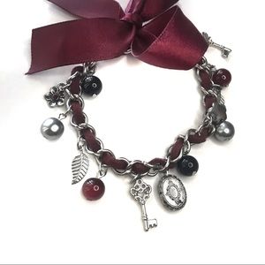 Maroon charm bracelet with bow